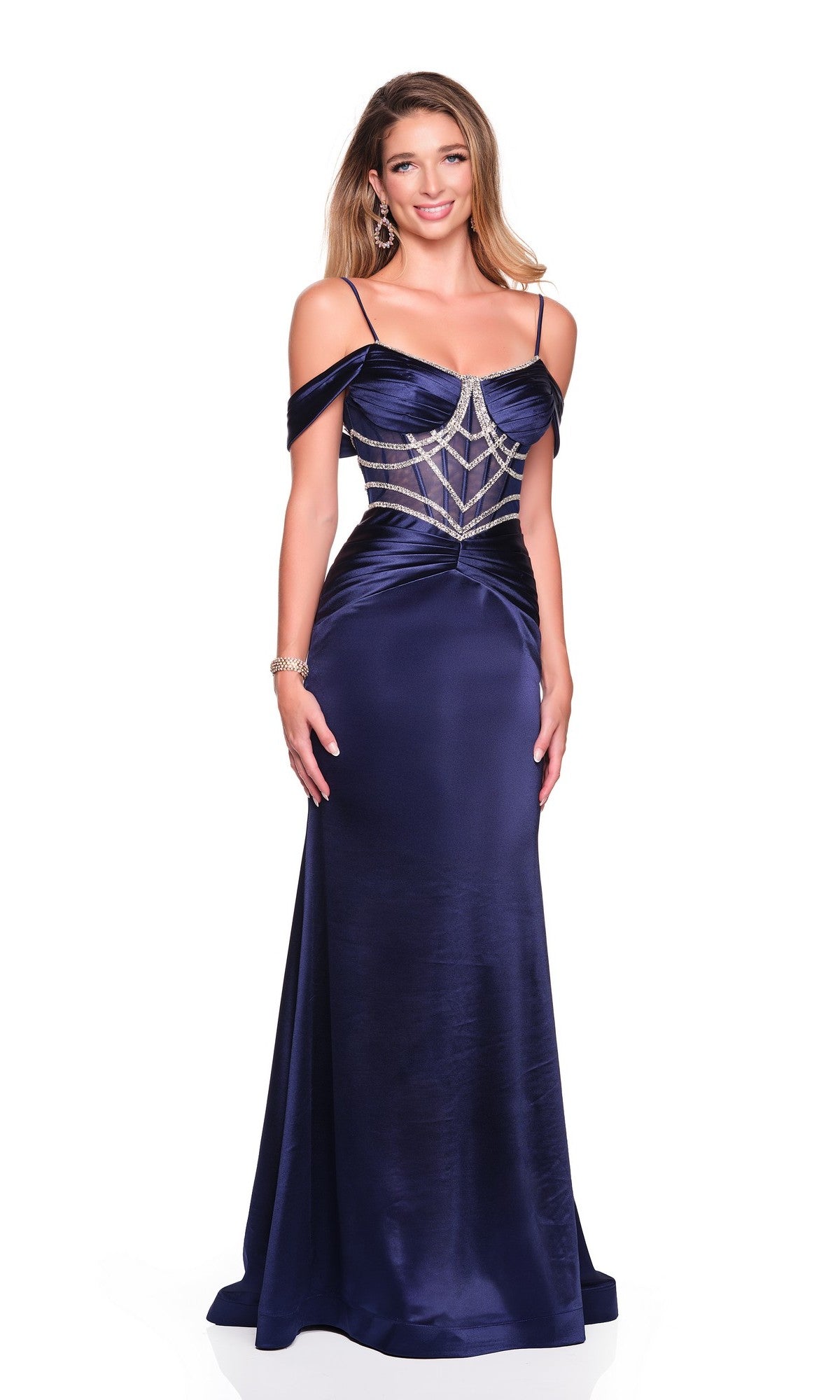 A woman wears the Dave and Johnny 12576 long prom dress, featuring navy blue satin, off-the-shoulder straps, and a beaded geometric bodice design.